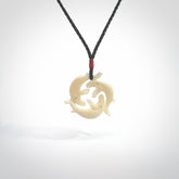Hand carved natural bone whale trilogy pendant. Art to wear. Ocean themed pendants.